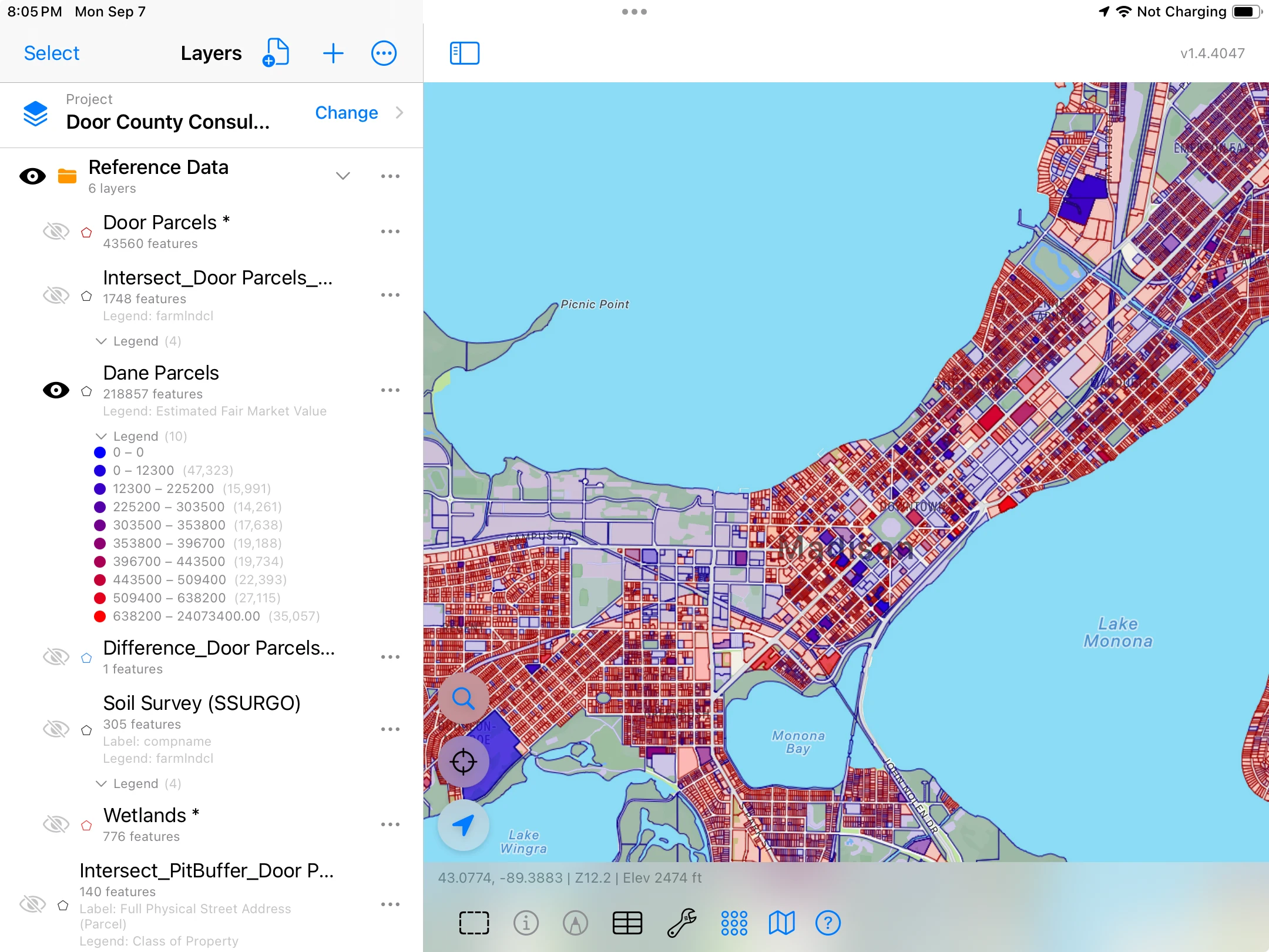 Dense parcel boundaries across Madison’s isthmus on iPad, colored by estimated fair market value, with a legend and a Dane Parcels layer listing 218,857 features.