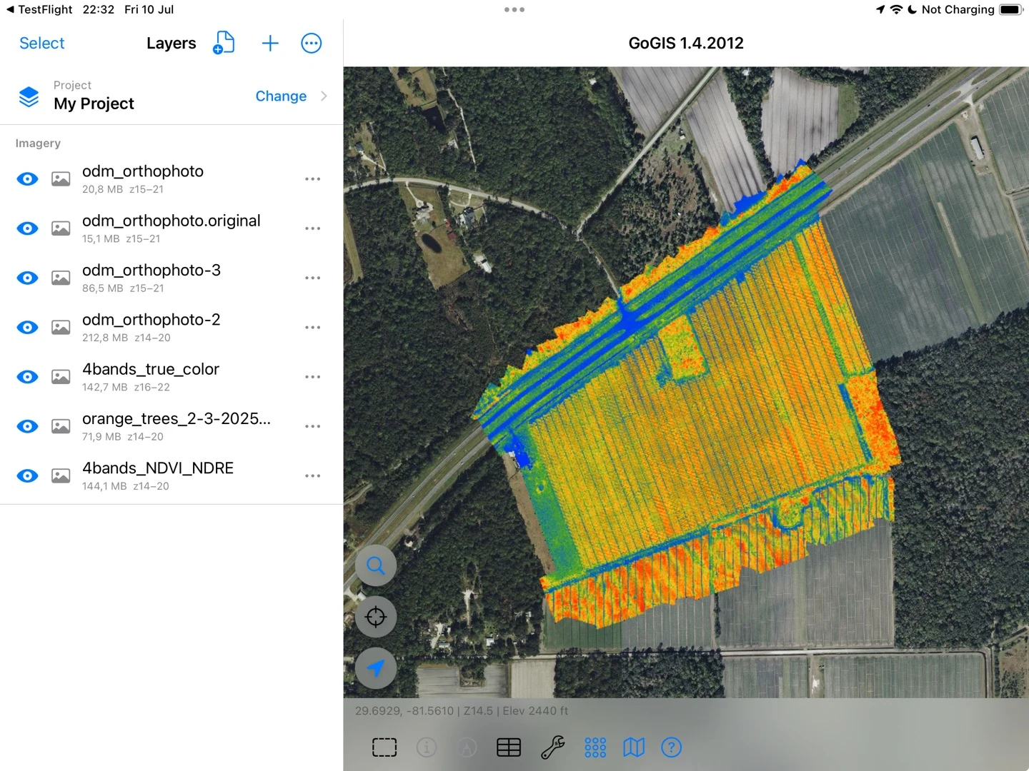 A colored raster layer over aerial imagery on iPad, with the imagery layers listed alongside the map.